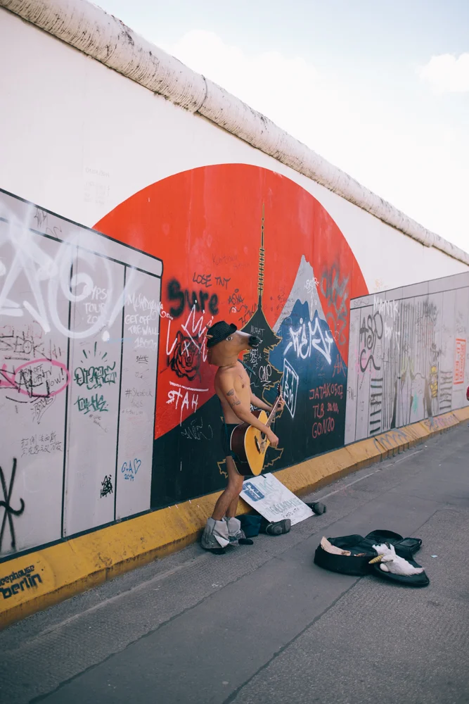 street performer alongside the wall