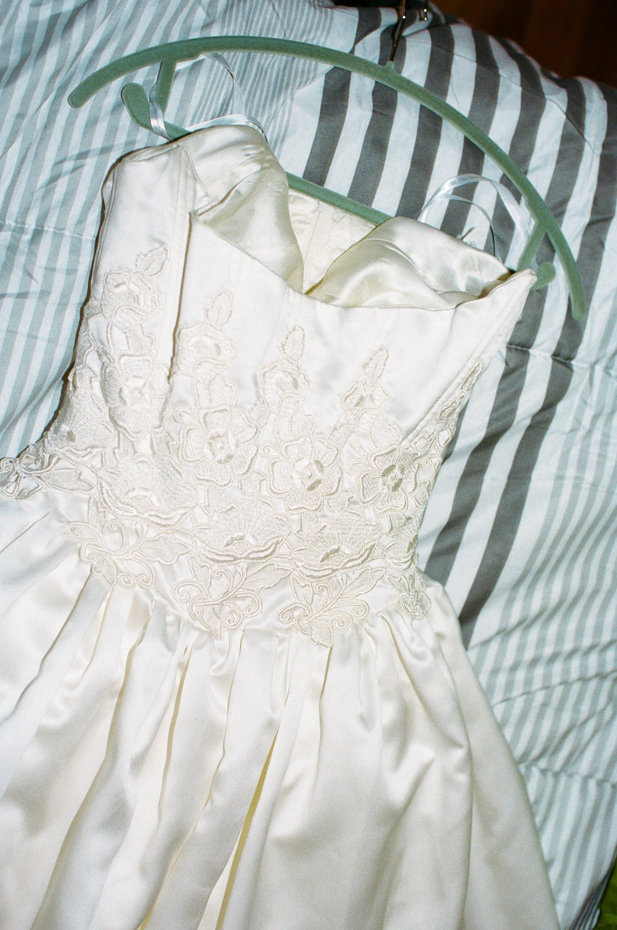 Bridal dress laying on bed