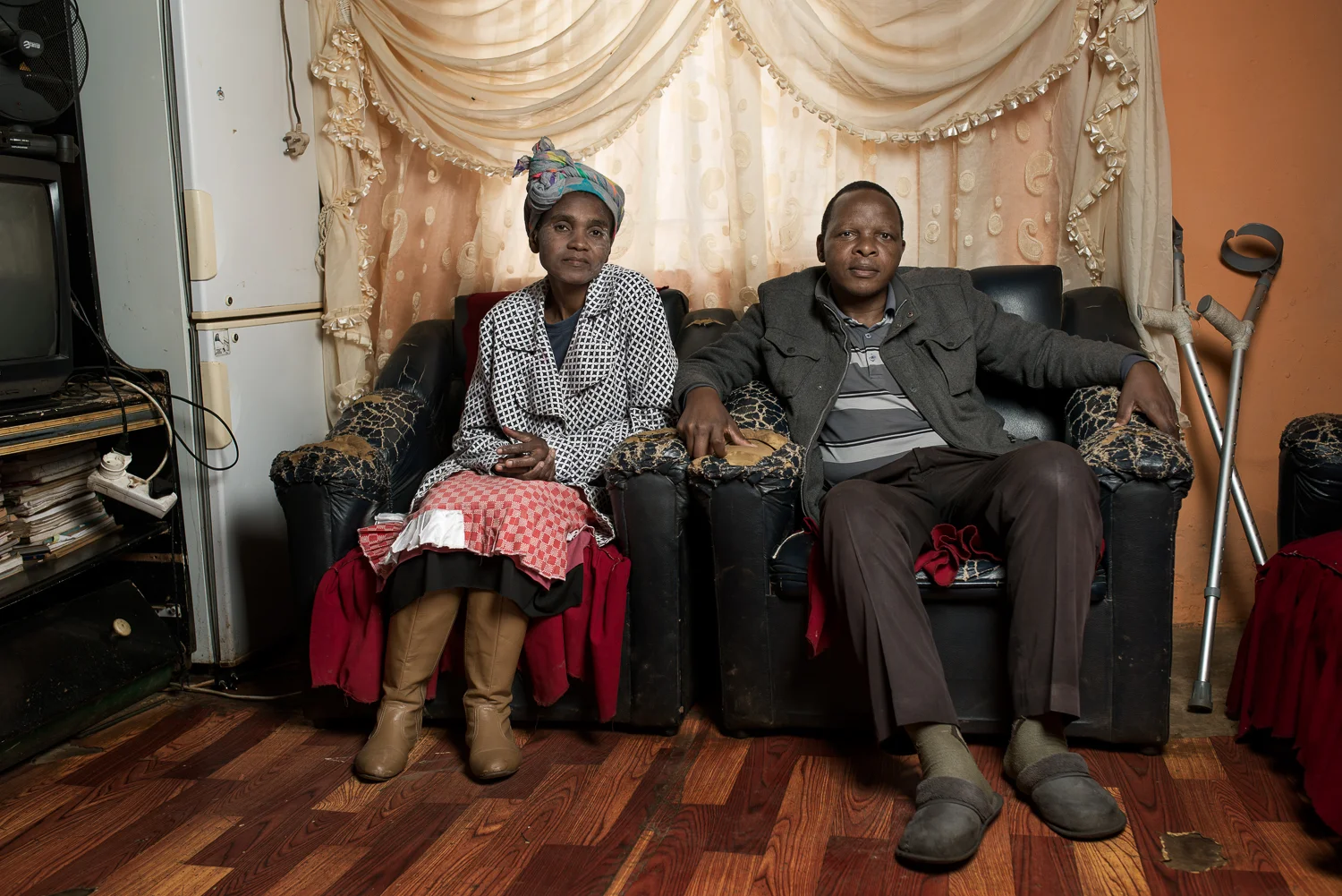 Landile Qebela , 52 years old, has nine children and works as a security guard now that he cannot work in the mines any longer. He has silicosis from his 32 years service at Vaal Reefs Shaft No 8 and received R52 000 compensation in 1995 (approx. £2,460 or $3,730). He stayed at the mine for another 5 years working as a locomotive driver on the surface until he was retrenched because they could not find a suitable job for someone so sick. Mr Qebela went to find work in the mines when he was 25 years old because his mother became sick and he needed to make money to provide for his sister's future. He managed to send enough money home over the years to support her until she gained her teacher’s certificate.