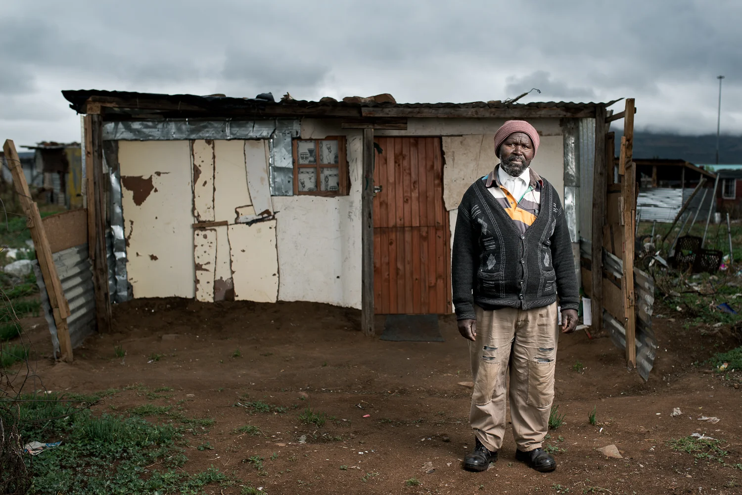 Mthuthuzeli Mtshange has 8 children. His family live in Flagstaff, 390km from Queenstown. He works as a gardener in Queenstown to make money to send home for his family. He is paid R50 a day (approx. £2.40 or $3.70). He lives in a township on the outskirts of Queenstown as it is all he can afford. Mr Mtshange worked on the gold mines for 35 years and was retrenched without reason in 1996. He was diagnosed with silicosis and tuberculosis and received no compensation from the mines.