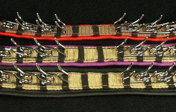 Here are our three sample collars, all with single leather lining and medium prongs . This photo shows the underside of the collars. They are, from top to bottom, 3/4 inch (red), 1 inch (purple) 1 1/2 inch (Black) Please remember the size of the collars are based on the web only, that is not the width of the over all collar after leather , the leather will add to the width and that my very on the leather you choose.
