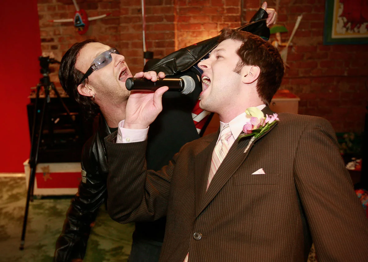 Groom sings with "Danno" of the U2 tribute band "Elevation" at the Catalyst Ranch Chicago.