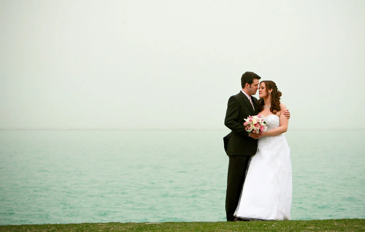Couple embraces near the Chicago Planetarium before their Catalyst Ranch wedding.