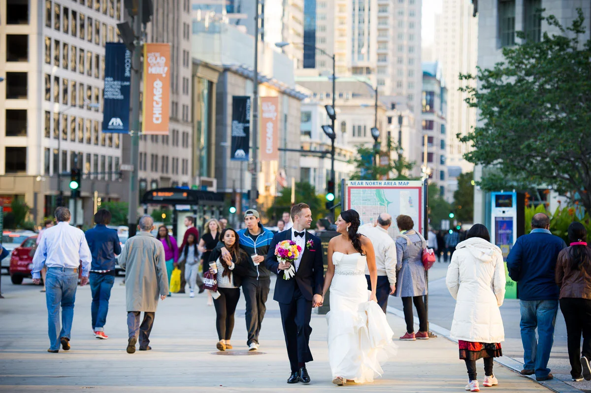 Couple strolls down Michigan Avenue on their wedding day.