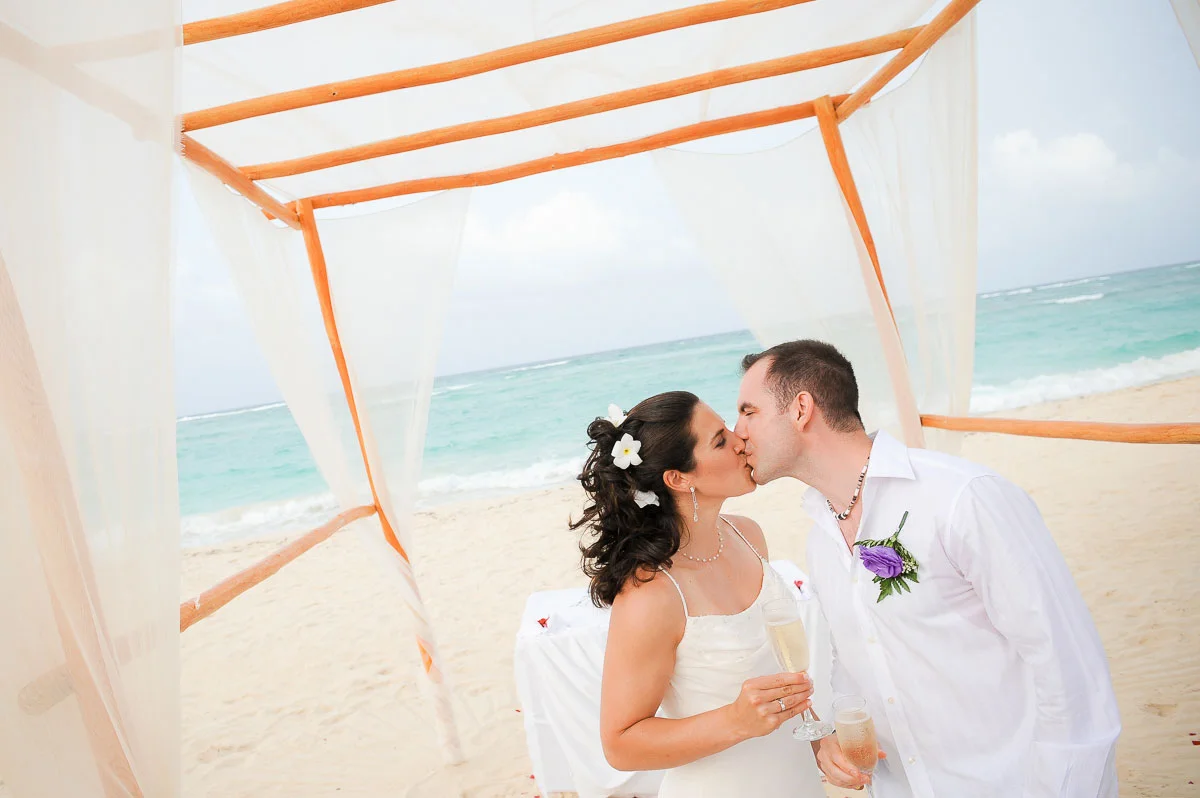 Bride & groom kiss after saying I do at the Majestic Colonial Resort, Punta Cana. 