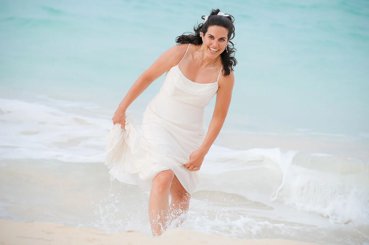 Bride takes a dip in the ocean after her wedding ceremony in Punta Cana. 