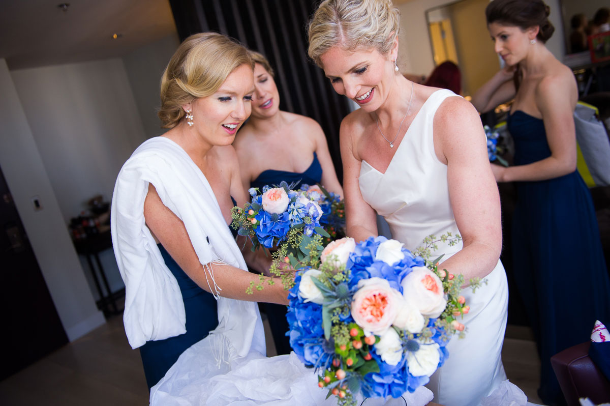 Bride receives her bouquet on her wedding day at the Thompson Chicago Hotel. 