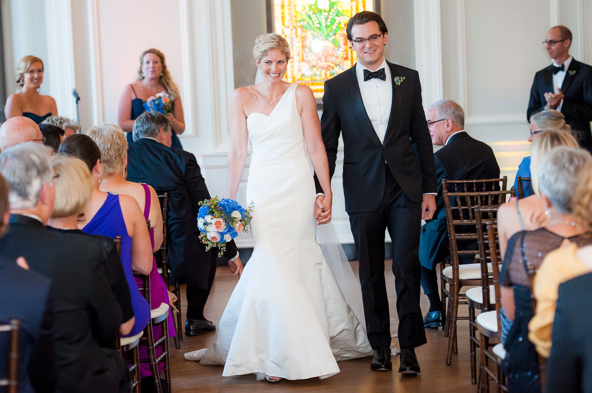 Bride & groom walk down the aisle during their wedding at the Chicago History Museum. 