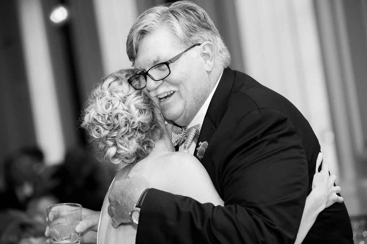Father & daughter embrace during a wedding reception at the Chicago History Museum. 