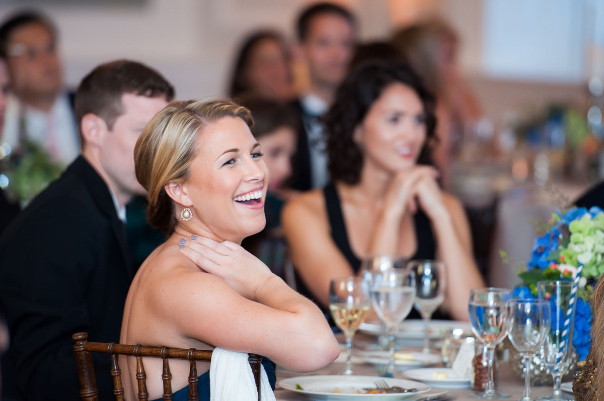Guests share a laugh during the speeches at a wedding reception at the Chicago History Museum. 