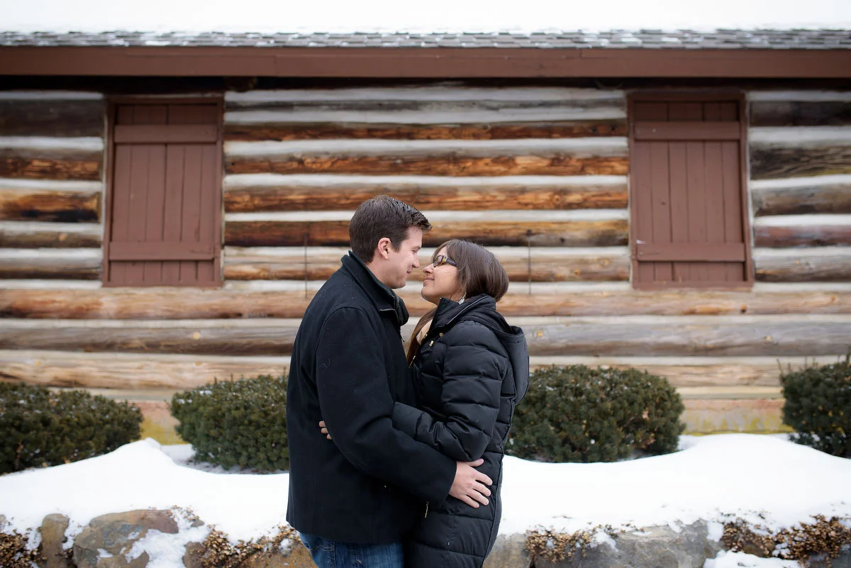 The couple embraces during their winter engagement session at Deicke Park in Huntley. 