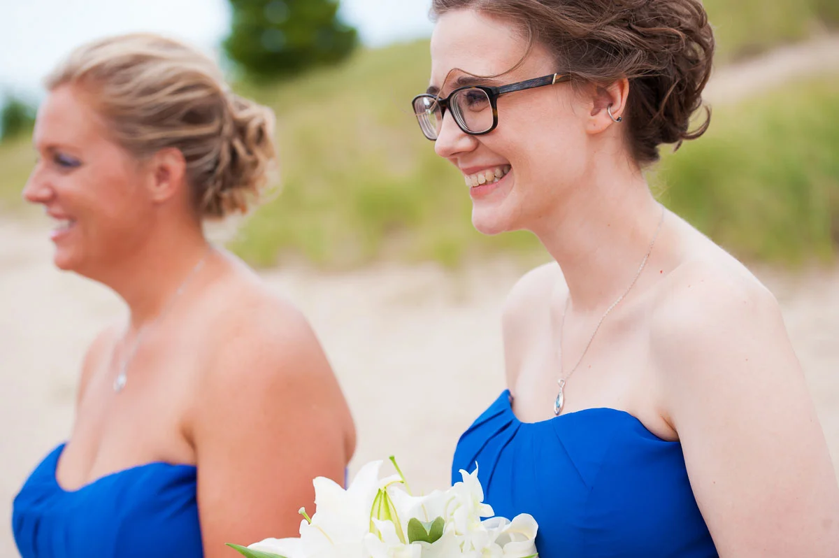 Bridesmaids smile during a wedding ceremony at Blue Harbor Resort in Sheboygan, Wisconsin. 