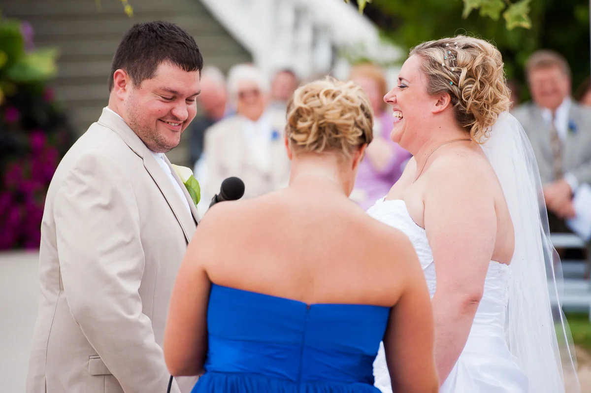 Bride & groom share a laugh during their wedding at Blue Harbor Resort. 