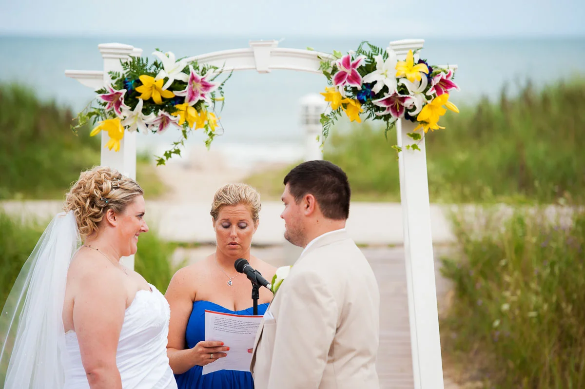 The maid-of-honor says some words of encouragement during a wedding ceremony at Blue Harbor Resort. 
