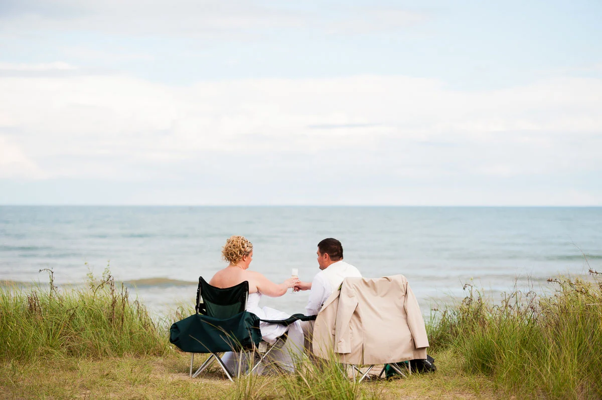 The newlyweds share a bottle of champagne after their wedding at Blue Harbor Resort. 