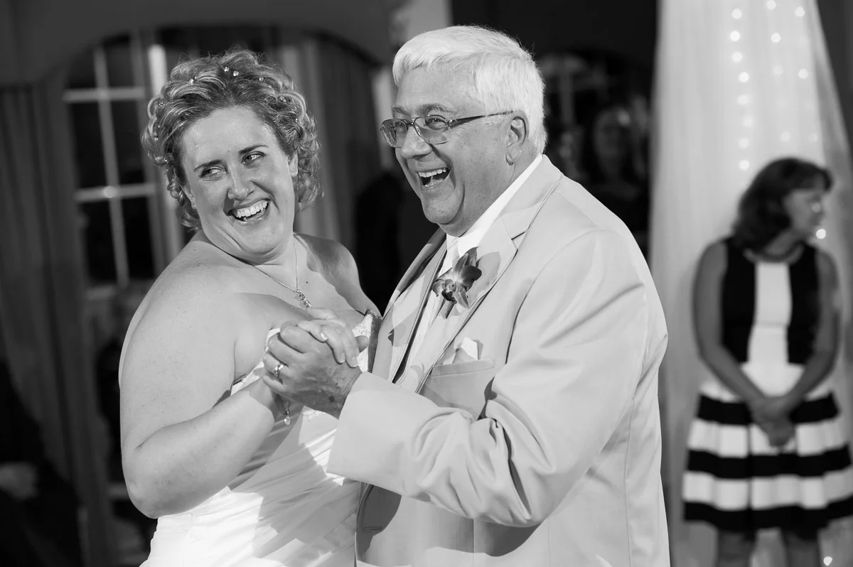 Father & daughter dance during a wedding reception at Blue Harbor Resort. 