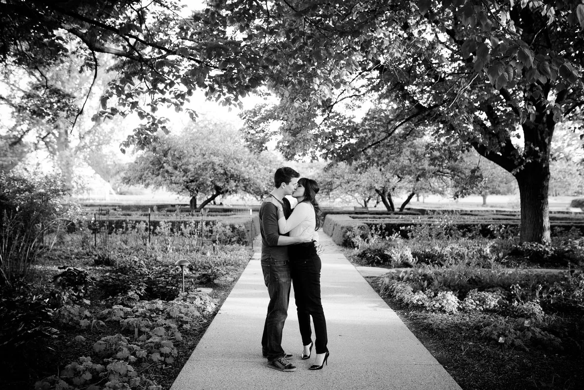 The couple stops to kiss during their engagement session at the Morton Arboretum in Lisle, IL. 