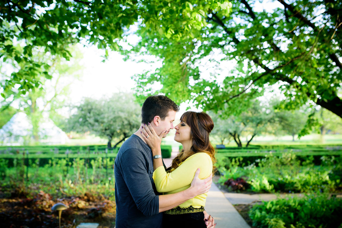 Couple embraces during their engagement session at the Morton Arboretum in Lisle, IL. 