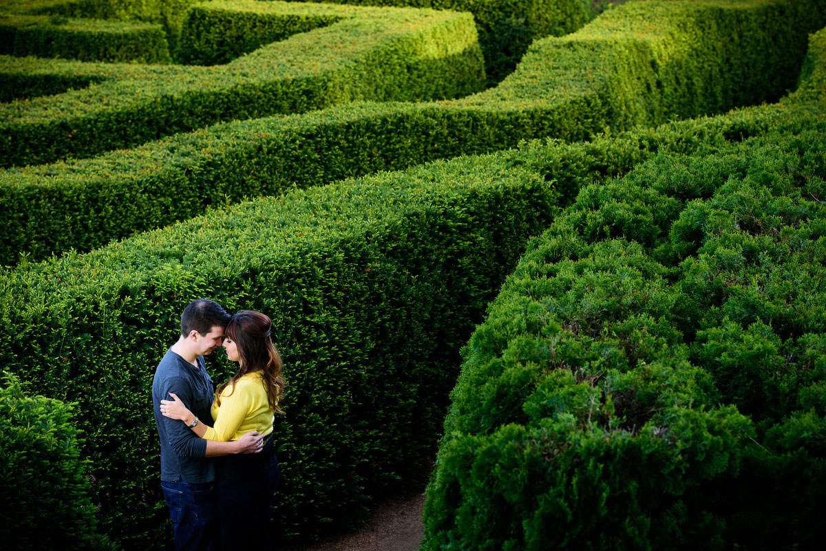Couple embraces in the maze garden during their engagement session at the Morton Arboretum in Lisle, IL. 