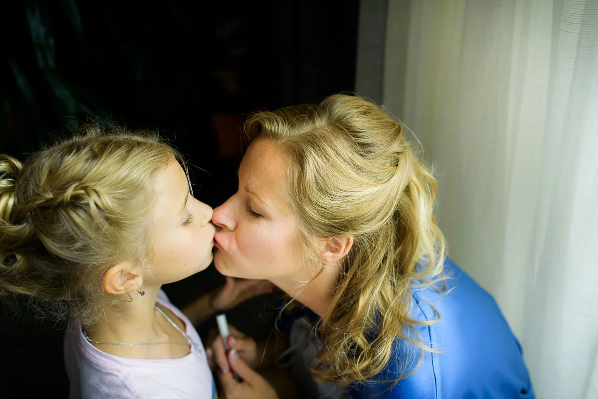 Mother and daughter kiss while getting ready before a wedding at the Trump Tower Chicago. 