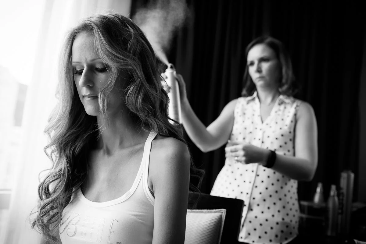 Bride finishes her hair at the Trump Tower Chicago before her wedding at the Harold Washington Library. 