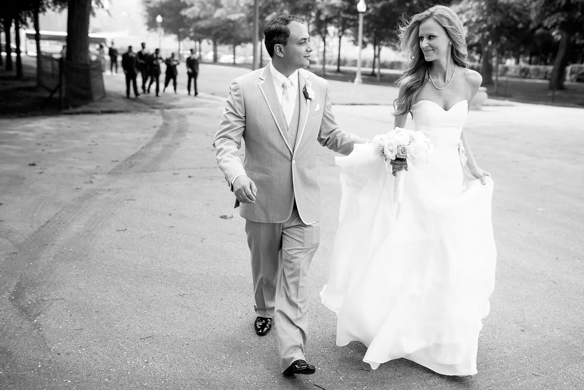 The couple walks through Grant Park for wedding photos. 