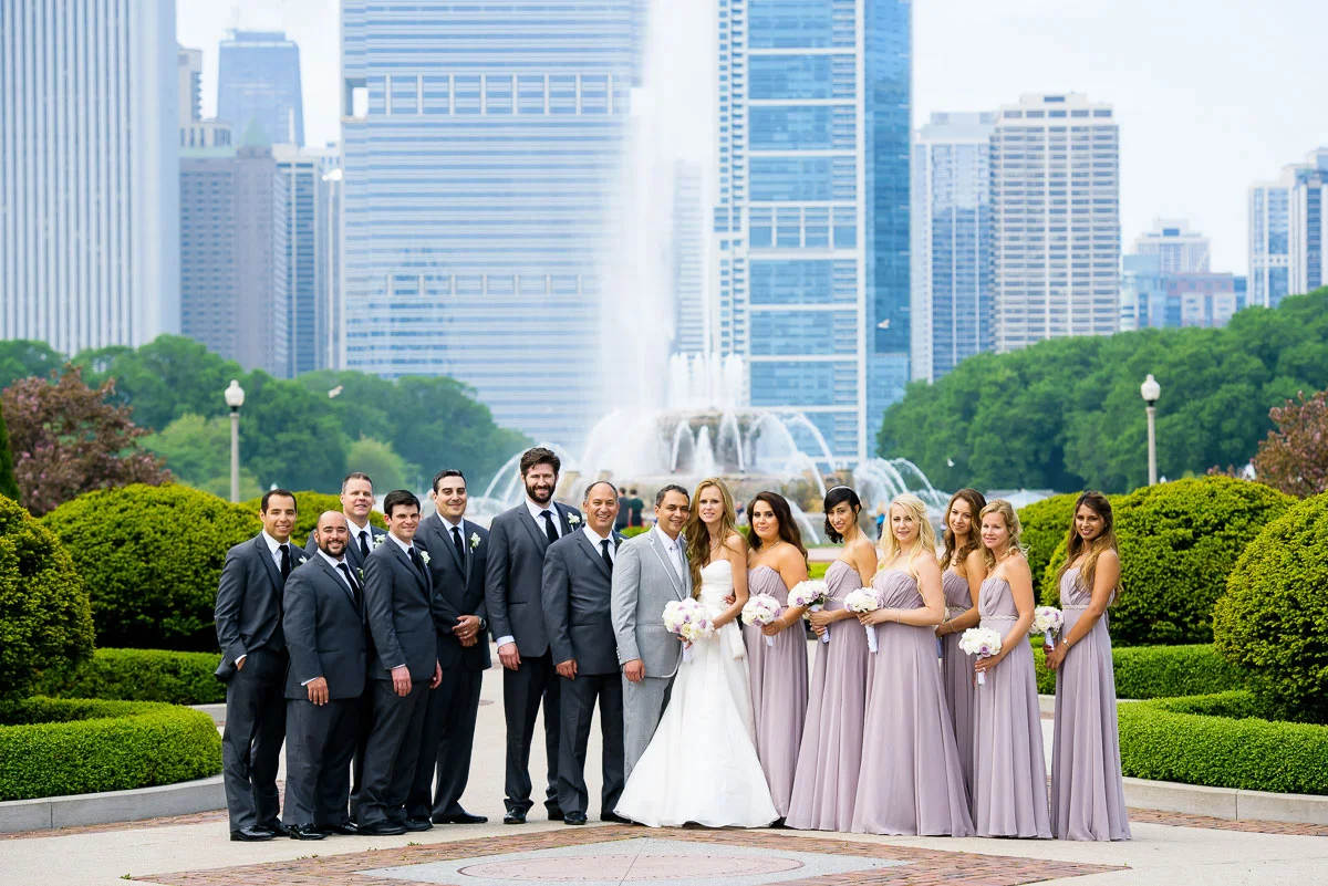 Bridal party photo at the Tiffany Gardens with Buckingham Fountain in the background. 