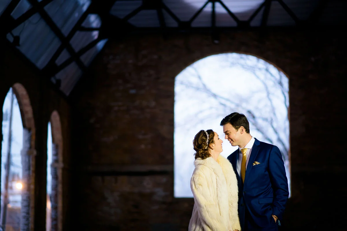 Bride & groom embrace in the sculpture garden during their Bridgeport Arts Center wedding. 