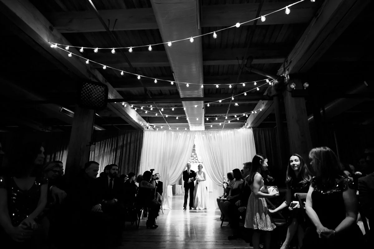 The bride walks down the aisle during her wedding at the Bridgeport Arts Center. 