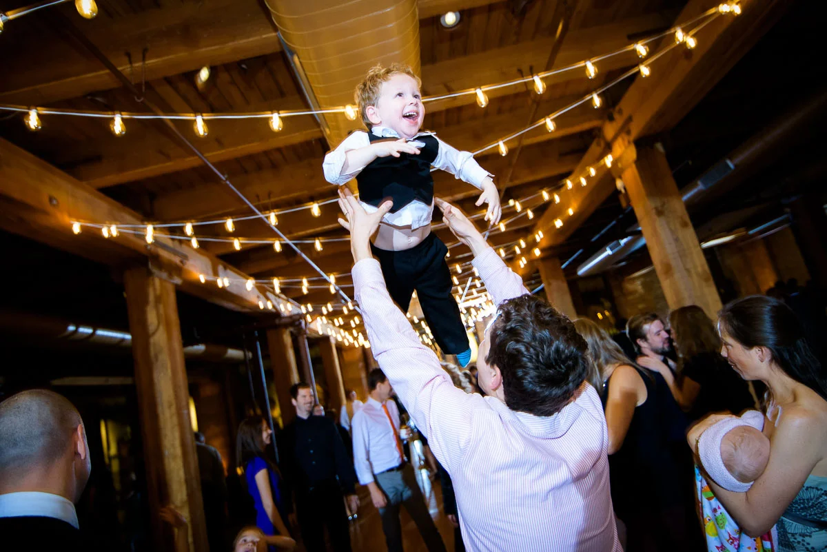 One of the ring bearers is tossed in the air during a Bridgeport Arts Center wedding. 