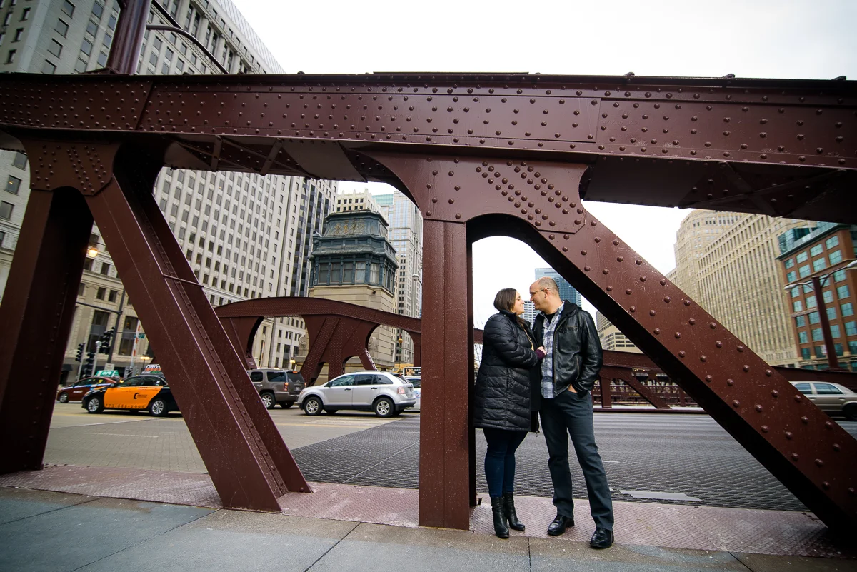Bride & groom stand under the LaSalle Street Bridge during their Chicago engagement session. 
