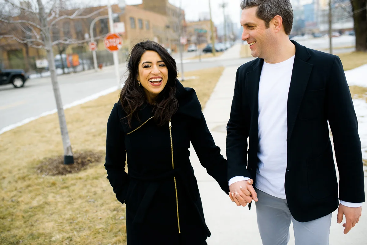 The couple shares a laugh during their Chicago engagement session near Fulton Market. 