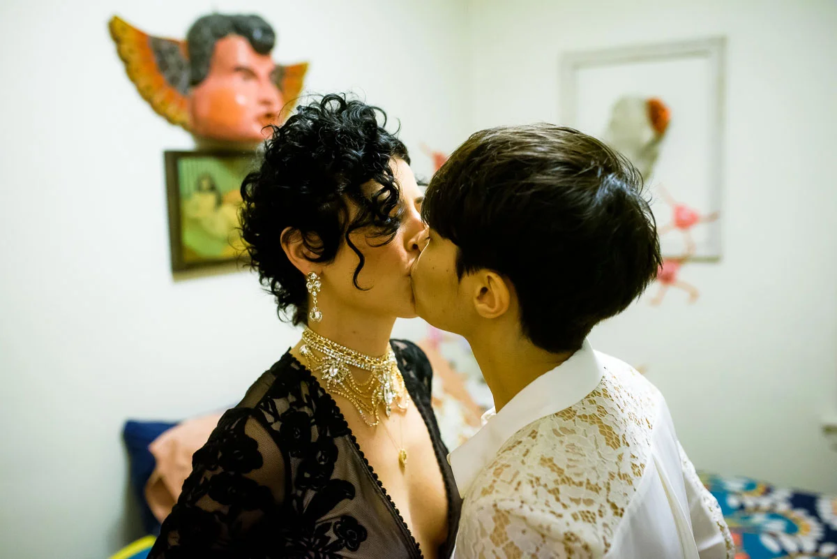 Same sex couple sneaks in a kiss before their wedding ceremony in Lincoln Square. 