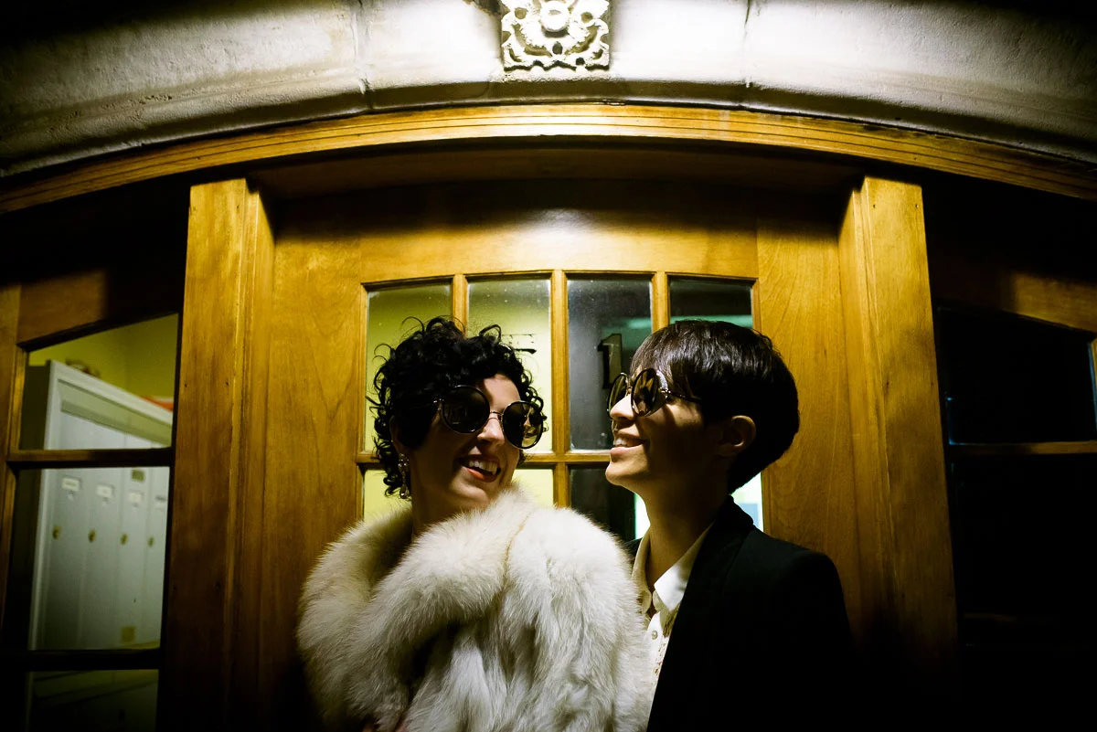 Same sex couple wedding night portrait outside their Lincoln Square apartment. 