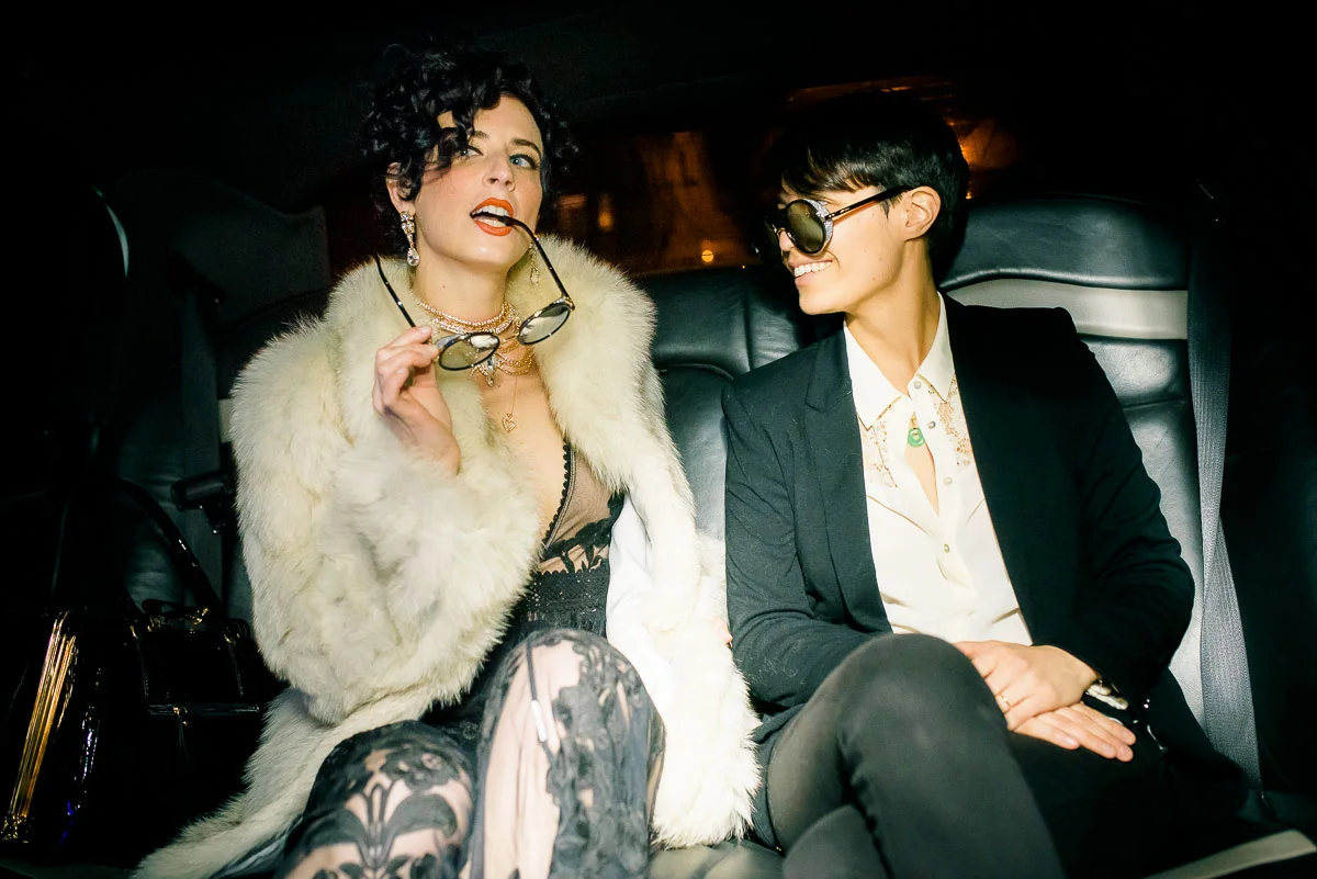 Same sex couple in a limo on the way to their Lincoln Square wedding at Tiny Lounge. 