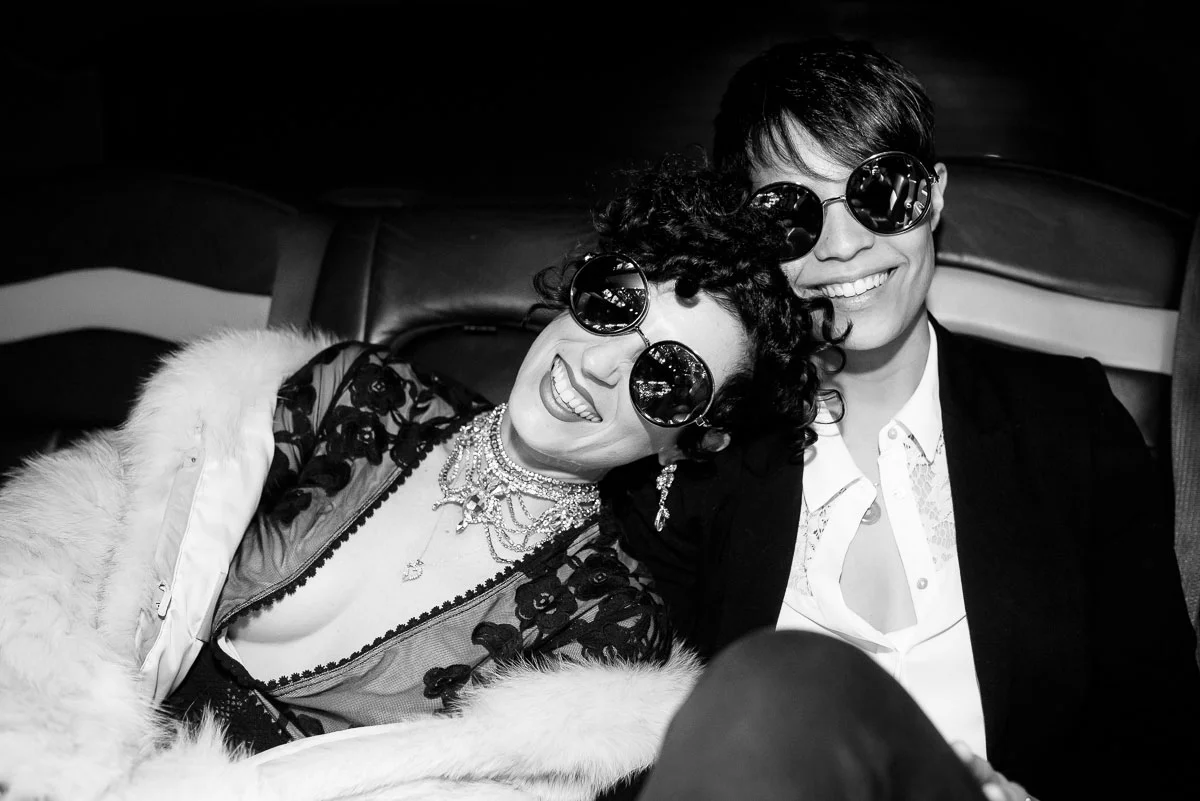 Same sex couple in a limo on the way to their Lincoln Square wedding at Tiny Lounge. 