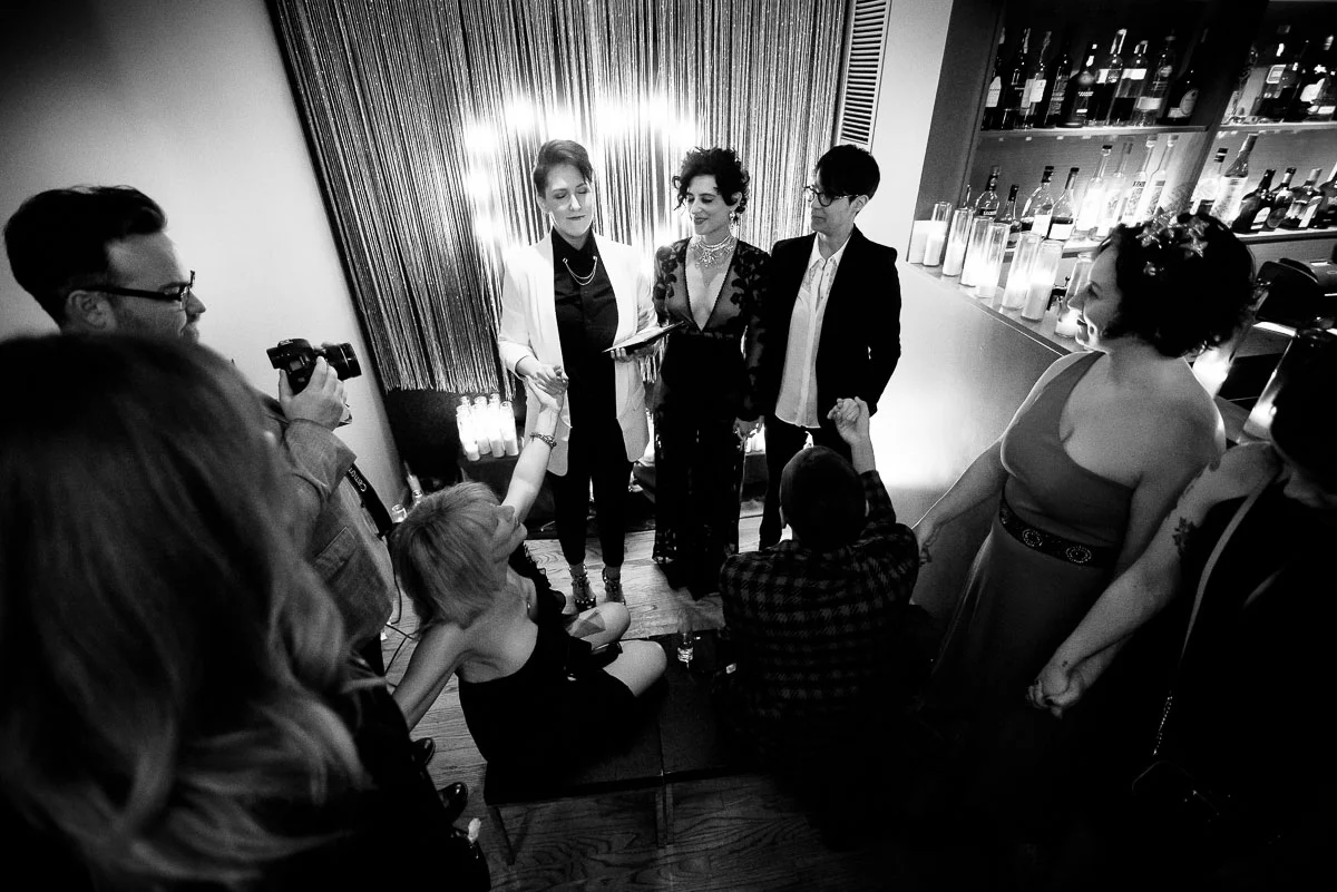 Friends and family come together for a same sex wedding ceremony at Tiny Lounge. 