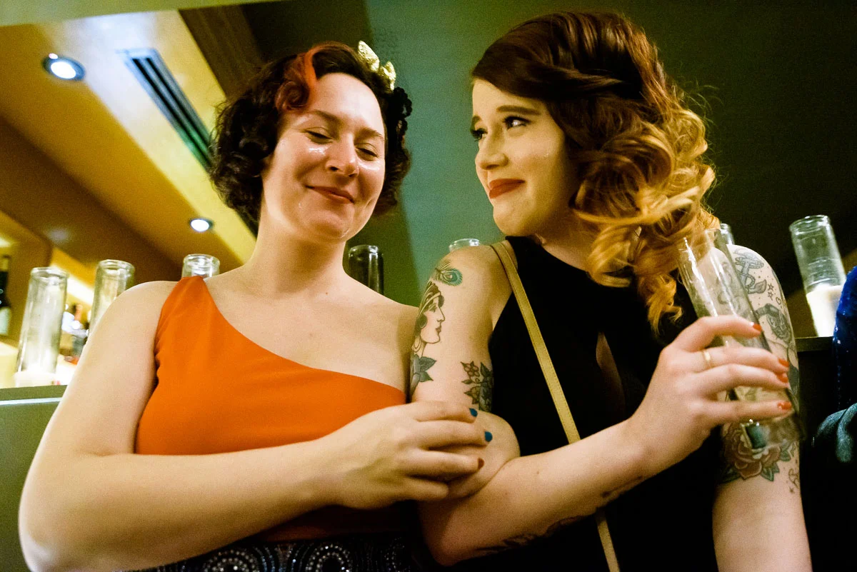 Friends share tears of joy during a same sex wedding ceremony at Tiny Lounge. 