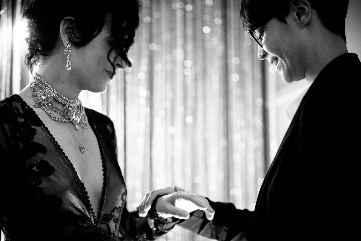 Same sex couple exchanges rings on their wedding day at Tiny Lounge. 