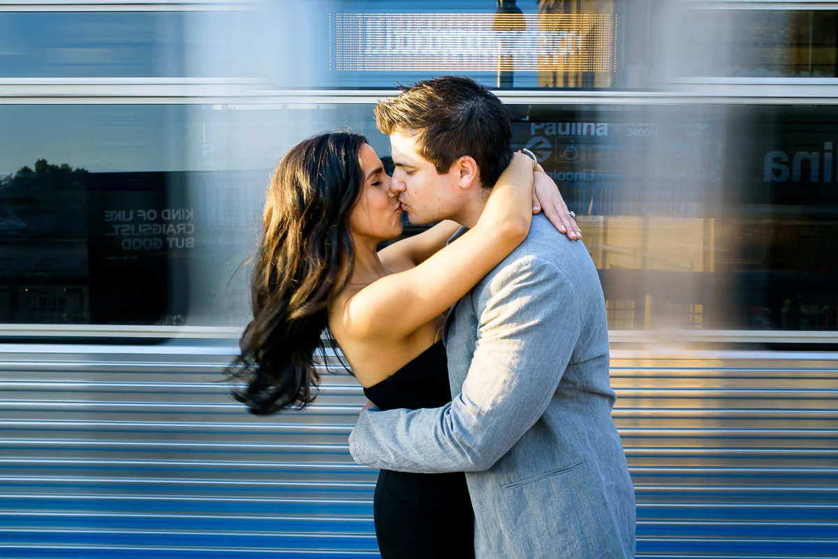 The el train flies past the couple during their Chicago engagement session. 