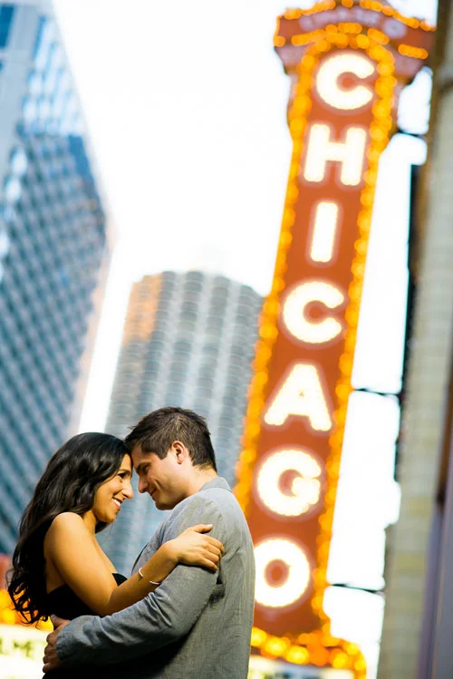 Couple stops by the Chicago Theater during their engagement session. 