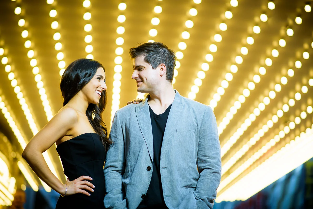 Bride & groom underneath the marquee of the Chicago Theater during their engagement session. 