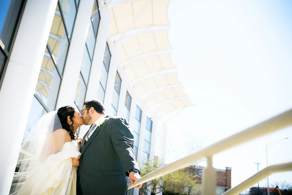 Bride & groom kiss outside the DoubleTree Skokie on their wedding day.