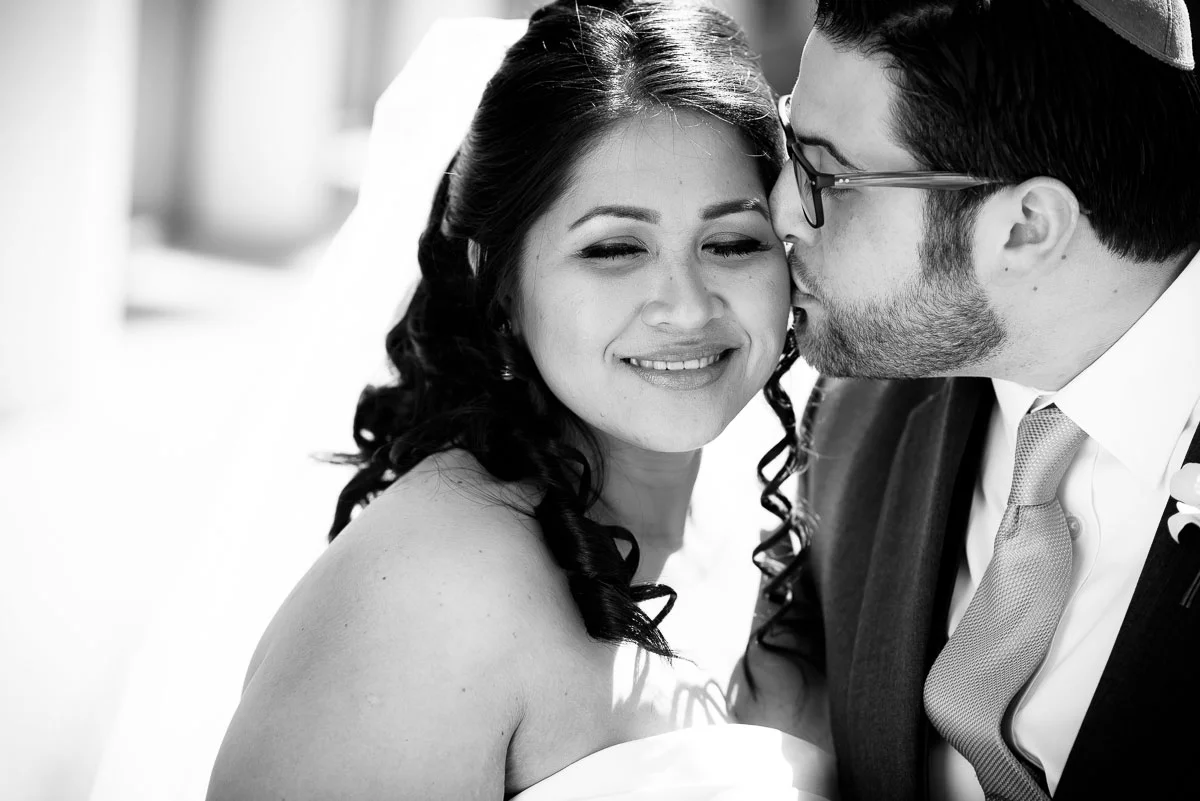 The couple shares a kiss on their wedding day outside the DoubleTree Skokie. 