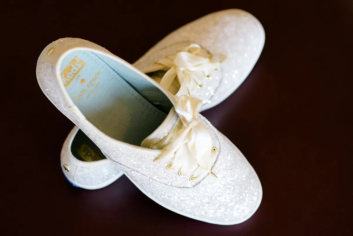 Detail photo of the bride's Keds by Kate Spade on the wedding day at the Thompson Chicago.