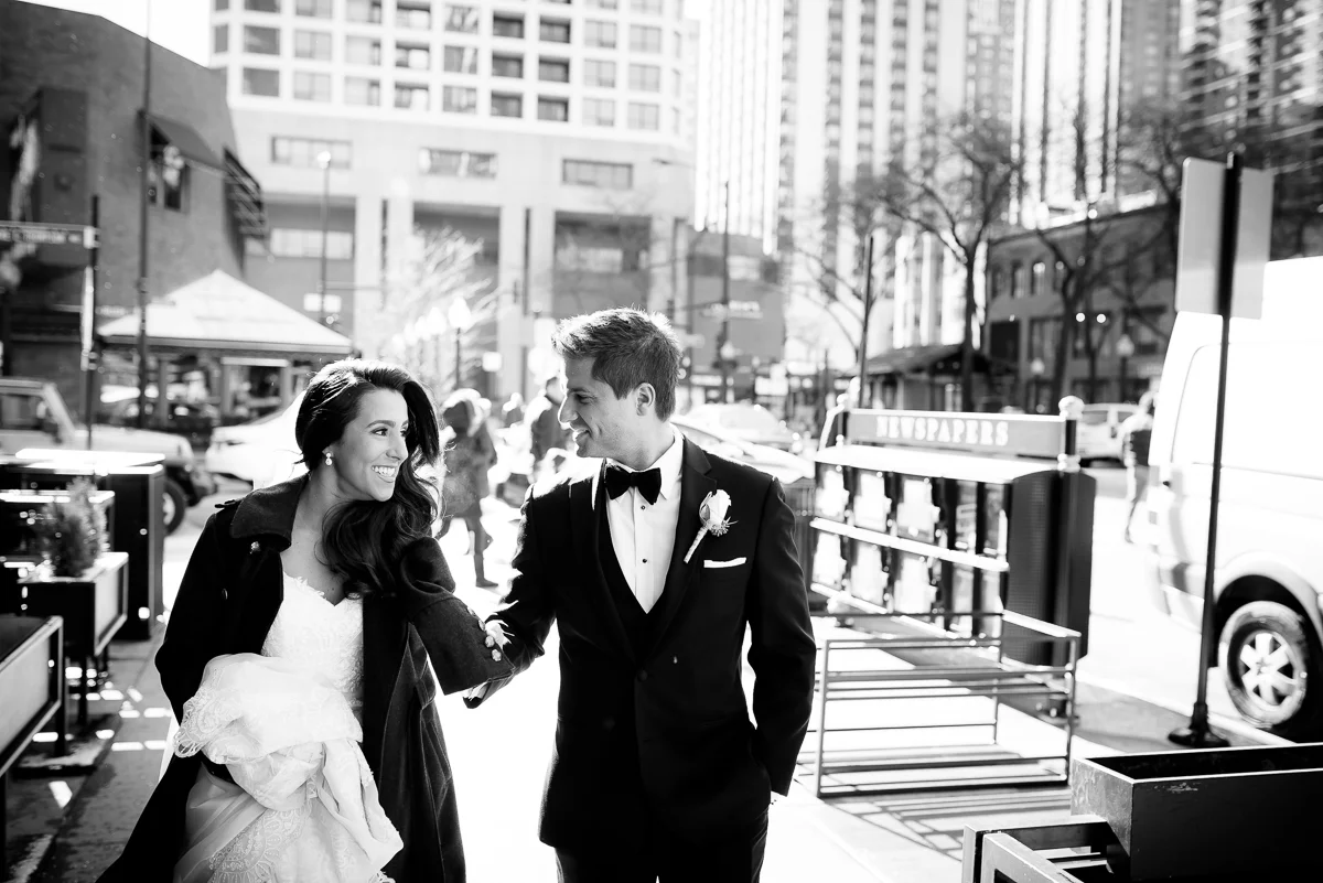 Bride & groom take a stroll through the Gold Coast on their wedding day at the Thompson Chicago. 