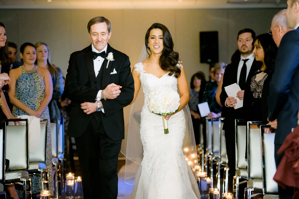 Father walks her daughter down the aisle during her wedding at the Thompson Chicago. 