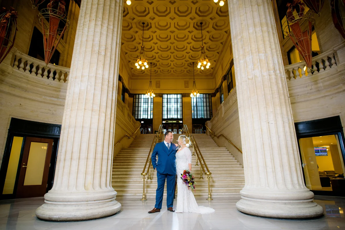 Wedding photo of the bride & groom near the grand staircase at Union Station Chicago. 