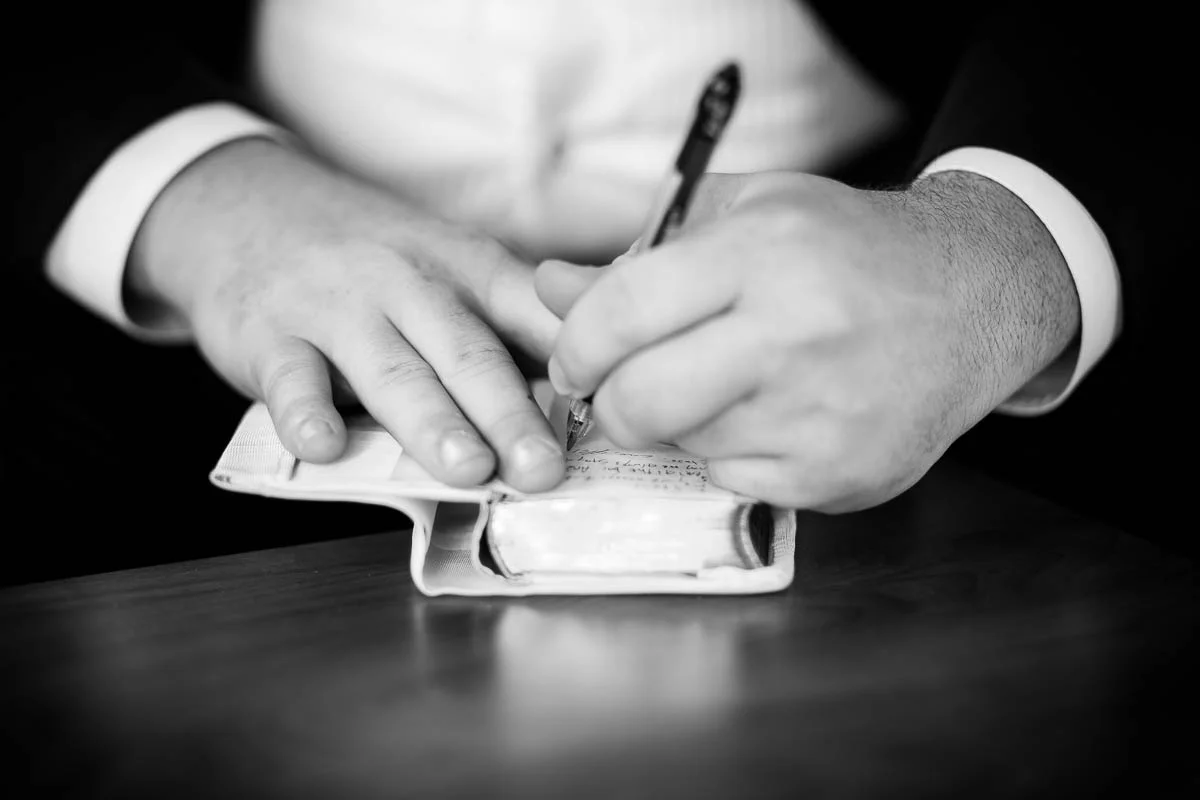 Groom writes a note to his bride before their wedding at Moonlight Studios Chicago. 