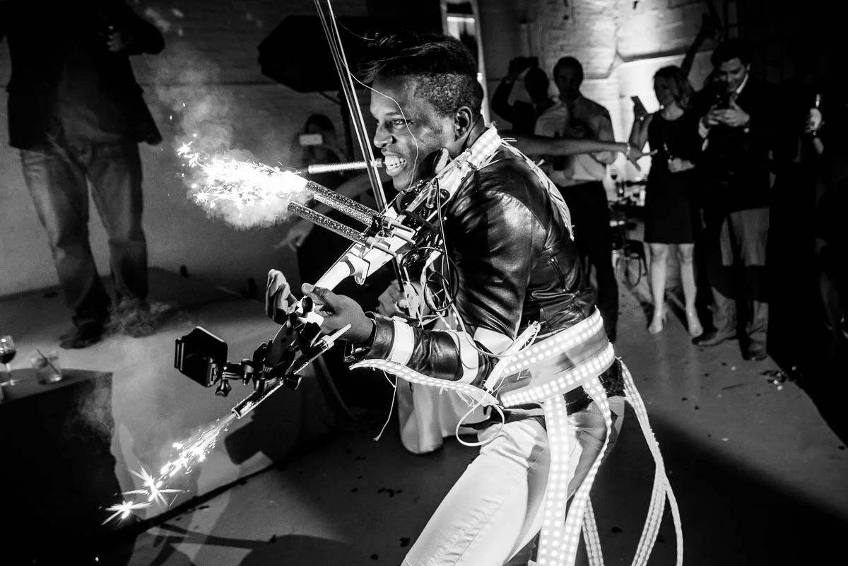 DJ/Violinist Timothee Lovelock lights sparklers on his violin during a wedding reception at Moonlight Studios Chicago. 